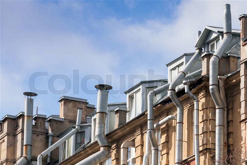 New attic windows in old living house roof with ventilation pipes, high-tech architecture fragment, stock photo