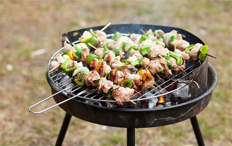 Grilling at summer weekend. Meet and fresh vegetables on grill, stock photo