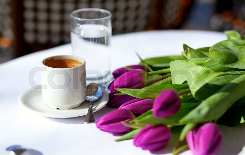 Spring coffee. Cup of fresh espresso and bunch of beautiful tulips, stock photo