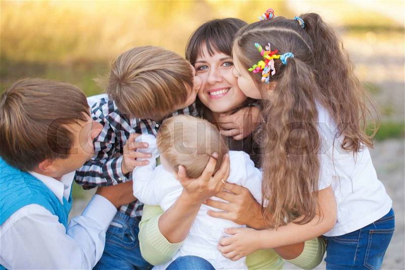 Large family hugging and having fun outdoors. , stock photo