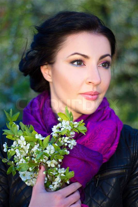 Close up portrait of young beautiful woman with cherry tree flowers, stock photo