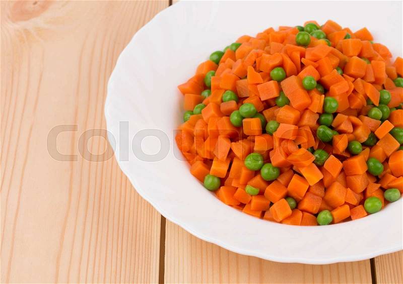Carrot salad on a wooden background in the closeup, stock photo