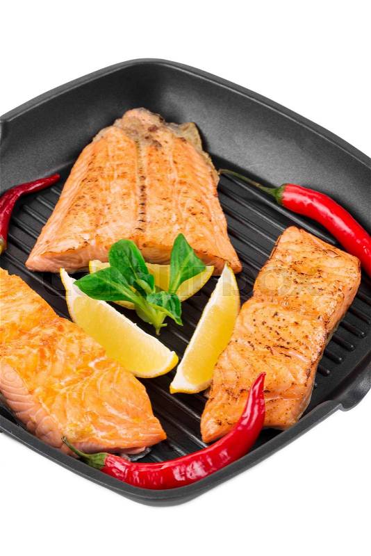 Frying pan with salmon steak. Isolated on a white background. , stock photo