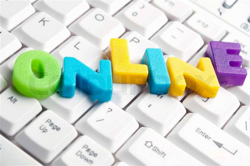 Online word made by colorful letters on keyboard, stock photo