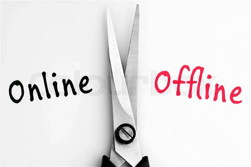 Online and Offline words with scissors in middle, stock photo
