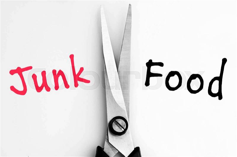 Junk and Food words with scissors in middle, stock photo