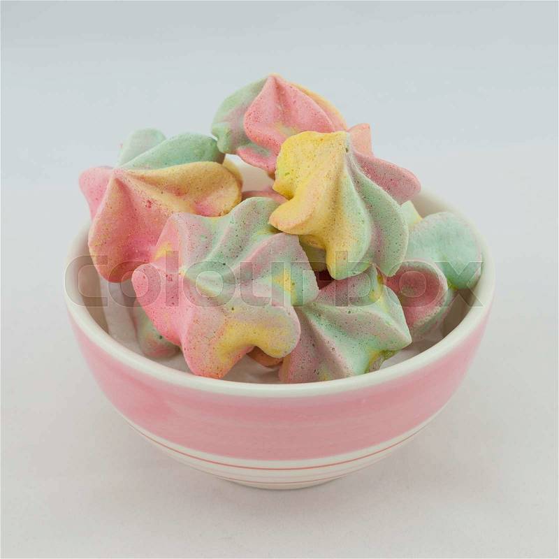 French rainbow meringue cookies on white background with copy space. Macro with shallow dof, stock photo