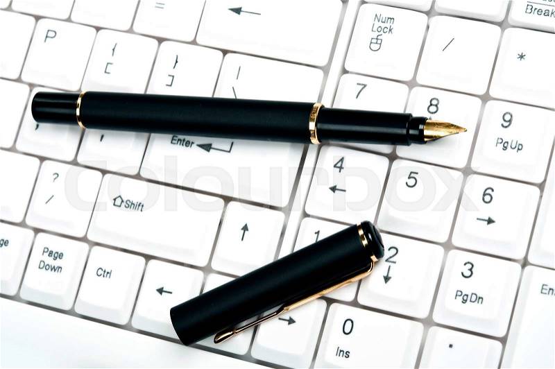 Pen on an white keyboard, stock photo
