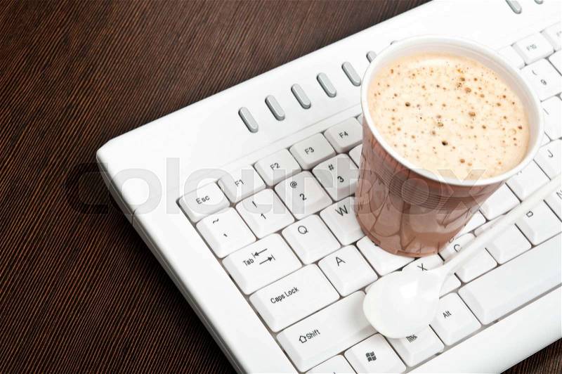 Coffee on an white keyboard, stock photo