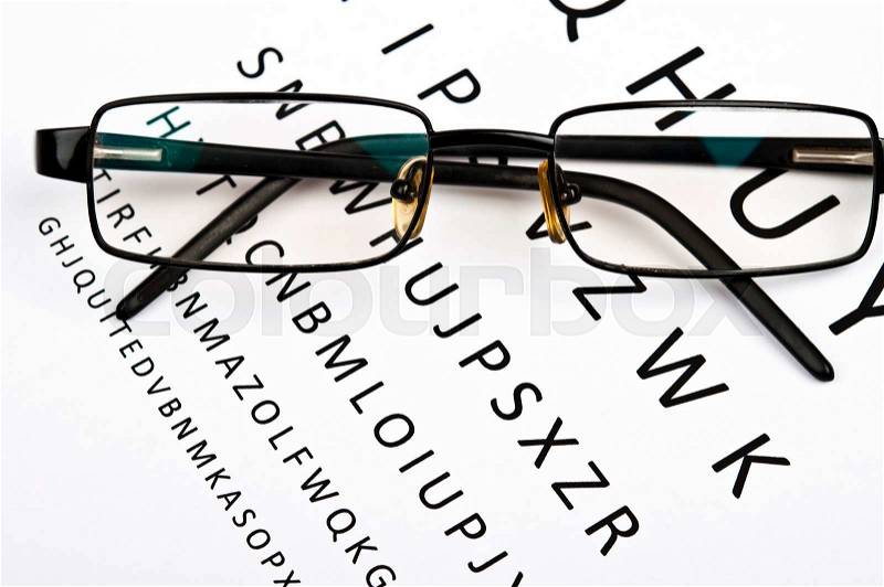 Eye glasses on examination paper, stock photo