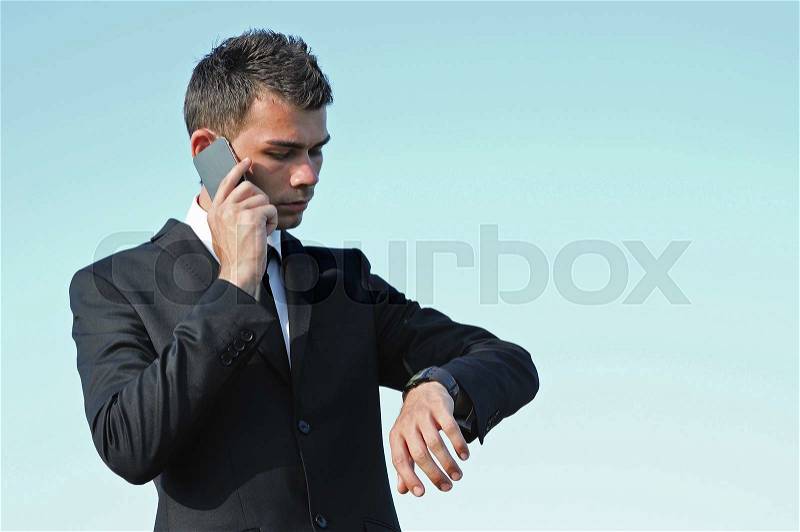 Business man looking at watch, stock photo