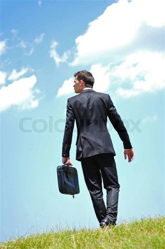 Business man walking in nature, stock photo