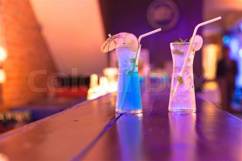 Cocktails on the bar counter in night club , stock photo