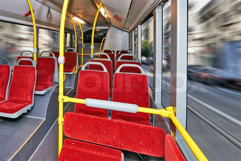 Public Transportation, City Bus Interior with red seats and streets background, stock photo
