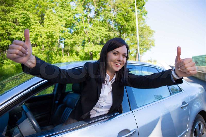 Driver license concept - happy woman with her car, stock photo
