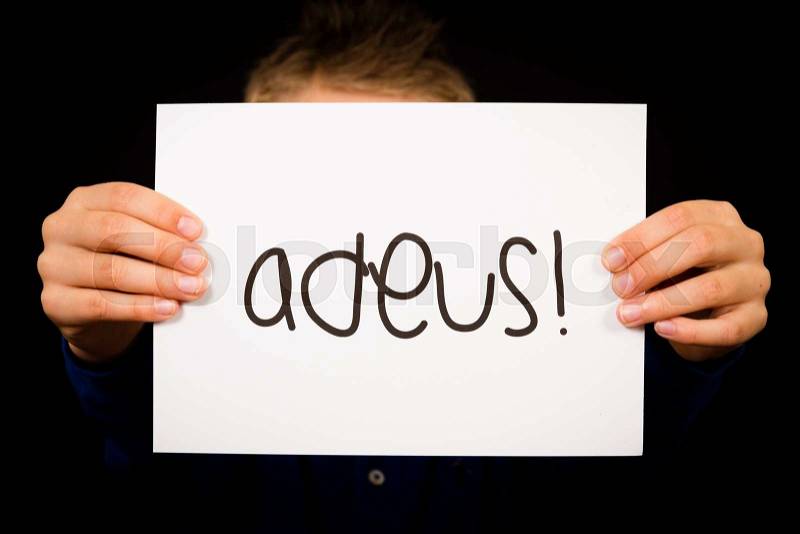 Studio shot of child holding a sign with Portuguese word Adeus - Goodbye, stock photo