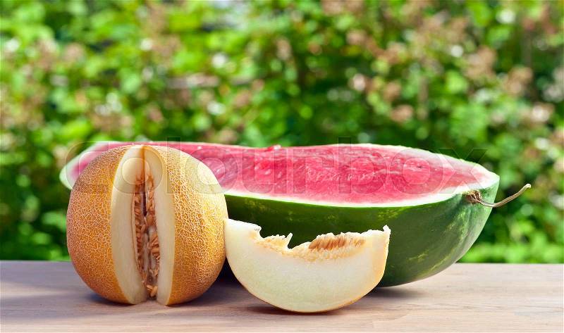 Ripe sweet melon on table in garden, stock photo