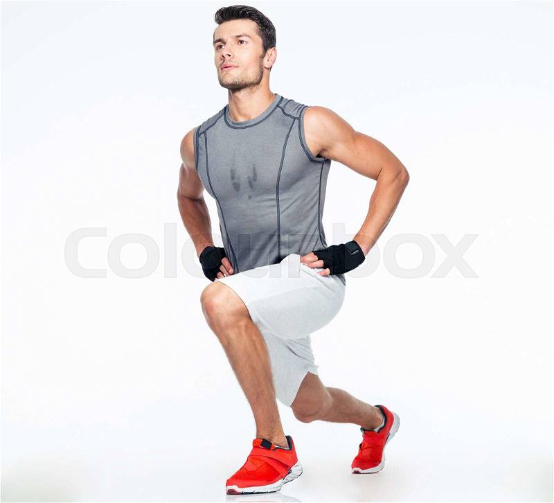 Full length portrait of a fitness man stretching isolated on a white background, stock photo