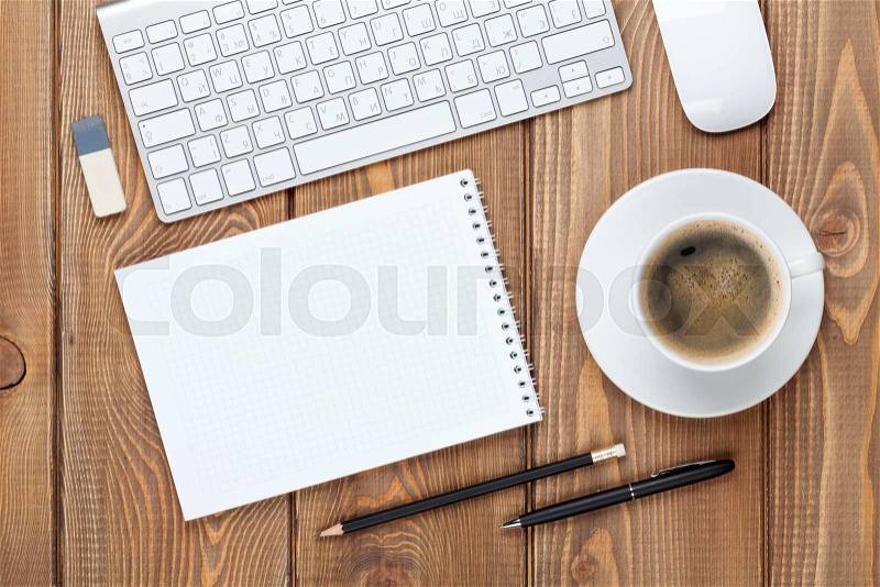 Office desk table with computer, supplies and coffee cup. Top view with copy space, stock photo