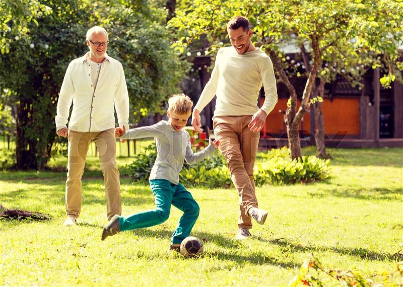 Family, happiness, generation, home and people concept - happy family playing football in front of house outdoors, stock photo