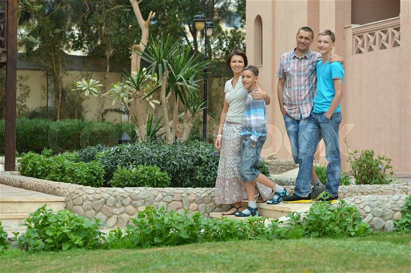 Happy Family in the garden at vacation resort, stock photo
