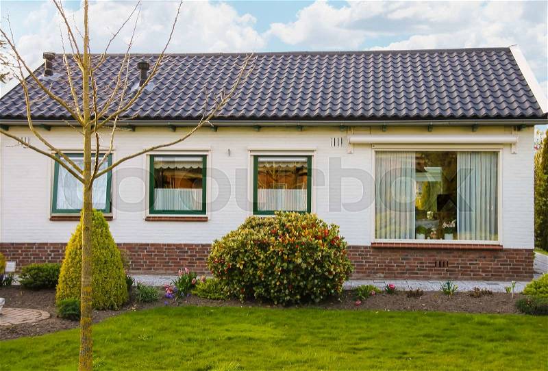 Residential building with a beautiful garden in Meerkerk, Netherlands, stock photo