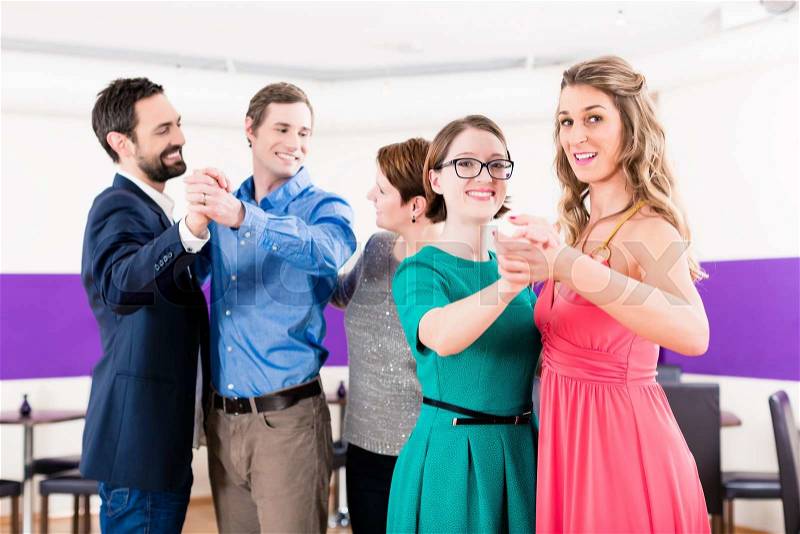 Dance instructor with gay couples in dancing class, stock photo