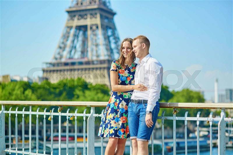Romantic couple having a date near the Eiffel tower in Paris, stock photo