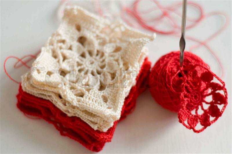 Crocheted pattern grandma\'s square, skeins and the crochet, stock photo