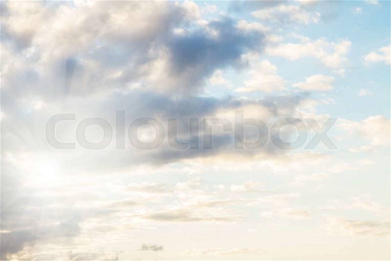 Storm sky with puffy white clouds and sunshine, stock photo