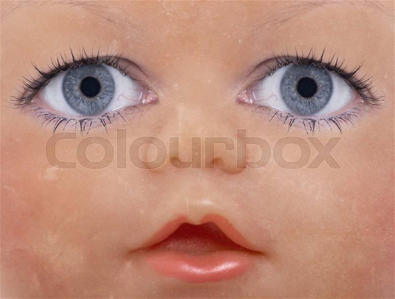 Scary doll face with human looking eyes, stock photo