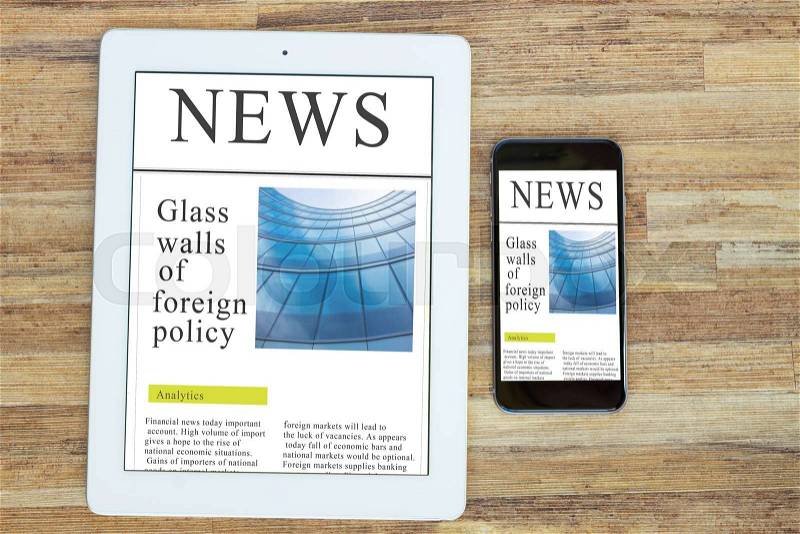 Modern computer devices tablet and phone with news site screen , stock photo