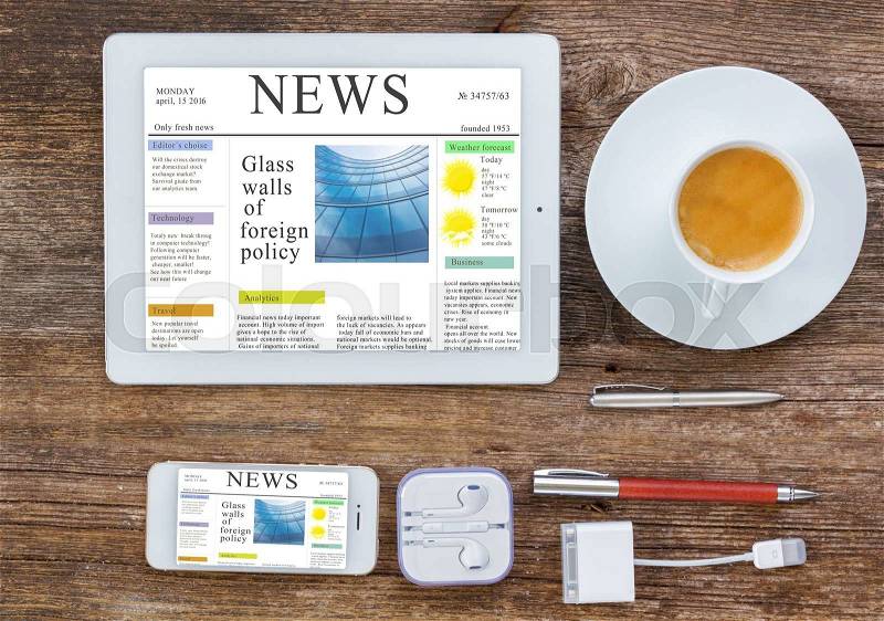 Top view office workplace - set of tablet, phone and cup of coffee on wooden background, news site on screen, stock photo