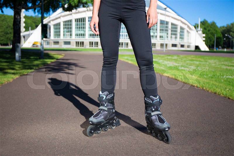 Inline skates - close up of slim female legs in skates, stock photo