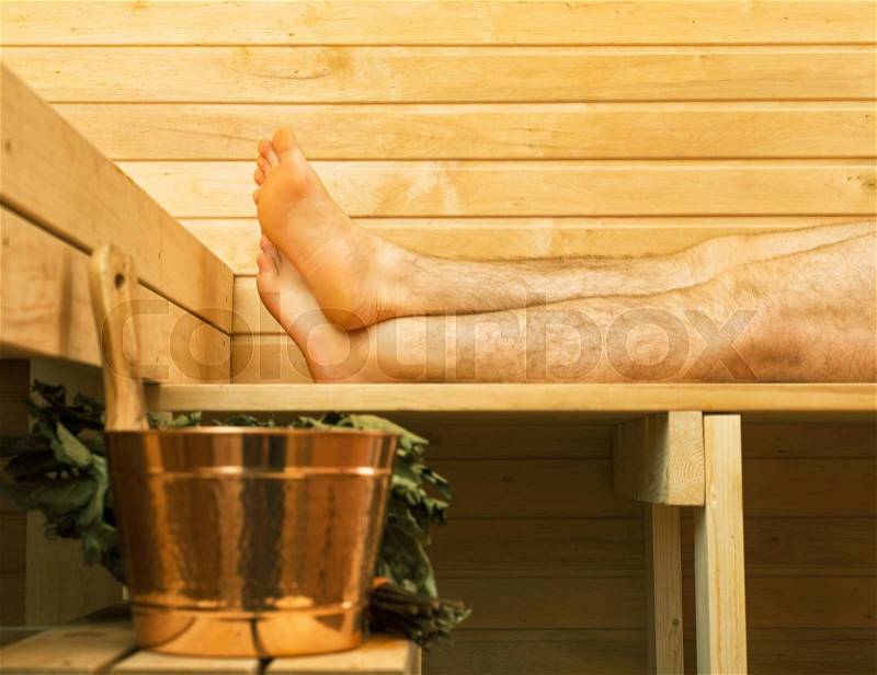 Spa accessories in sauna. Man on background, stock photo