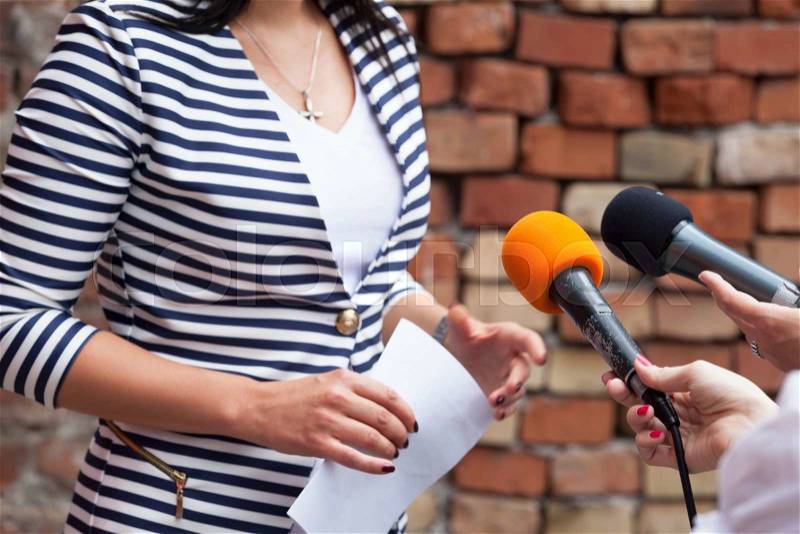 Journalist making media interview with woman, stock photo