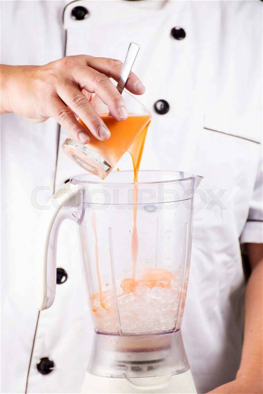 Chef pouring Thai Tea smoothie to the glass, stock photo