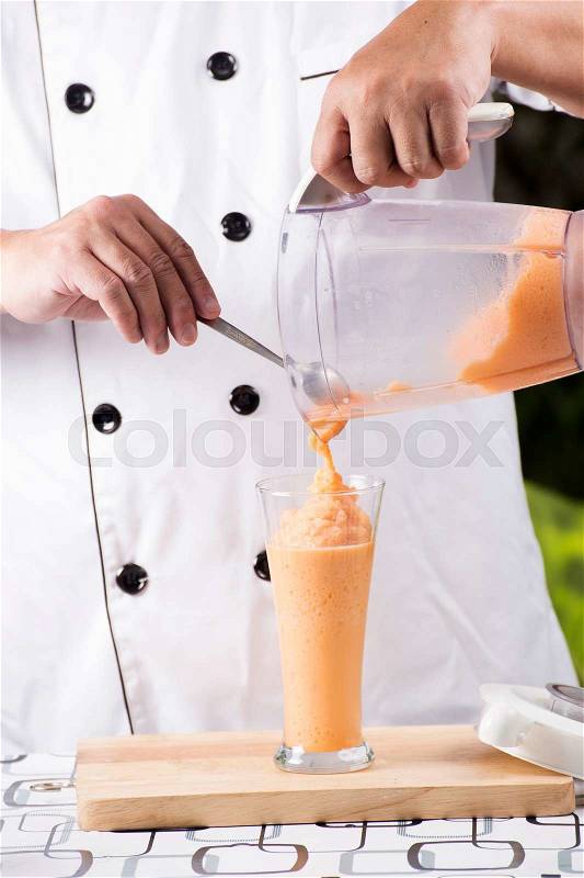 Chef pouring Thai Tea smoothie to the glass, stock photo