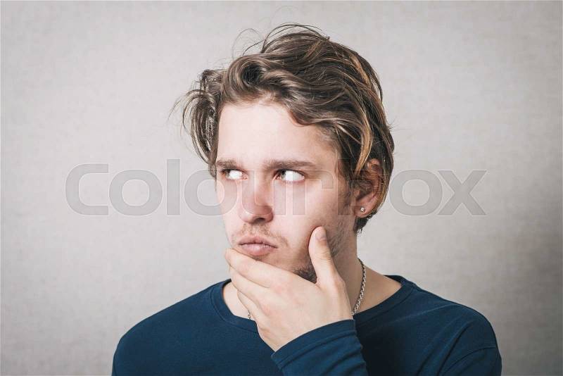 Men think looking to the left. Gray background, stock photo