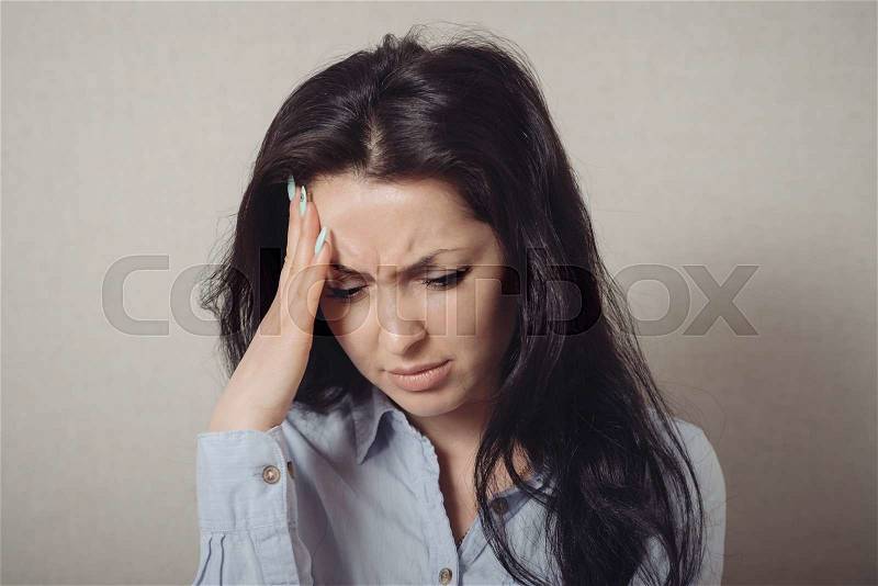 Woman hand on his head, remembered, forgotten. Gesture. On a gray background, stock photo
