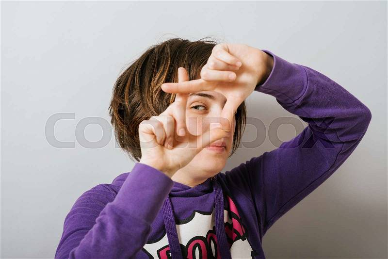 Girl making a frame for a photo, stock photo