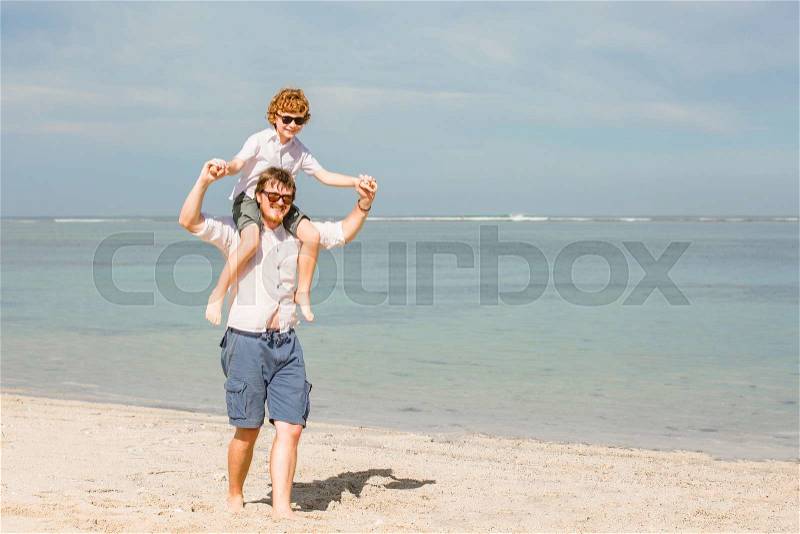 Hipster father with beard and red haired son having great happy time at a summer day. Vacation, happy and friendly family, holidays concept, stock photo