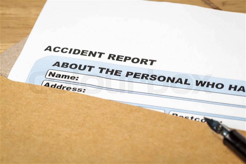 Accident report application form and pen on brown envelope, business insurance and risk concept; document is mock-up, stock photo