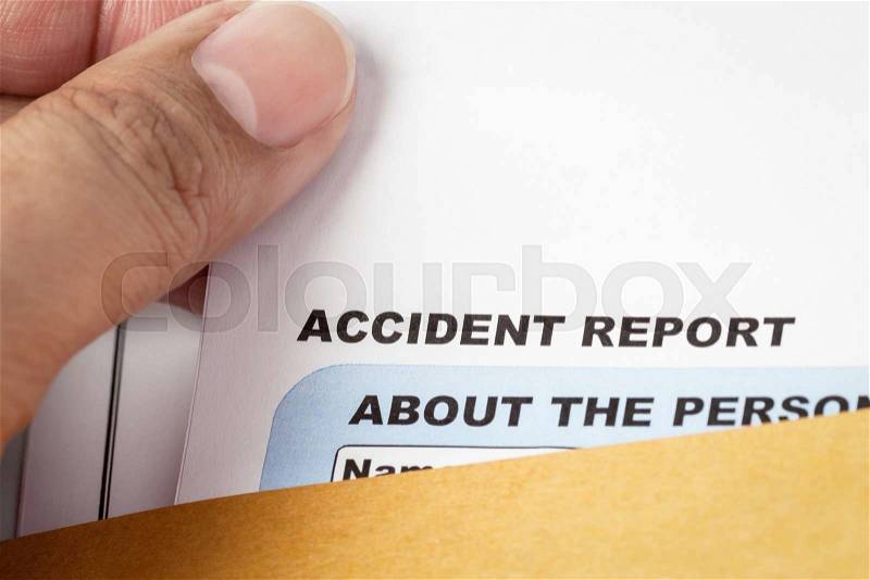 Accident report application form and pen on brown envelope and eyeglass, business insurance and risk concept; document is mock-up, stock photo
