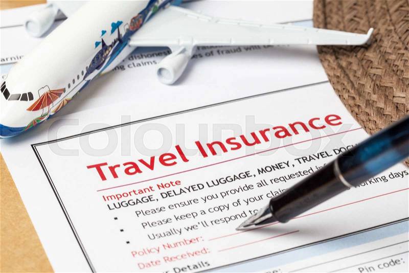 Travel Insurance Claim application form and hat with eyeglass and pen on brown envelope, business insurance and risk concept; document and plane is mock-up, stock photo
