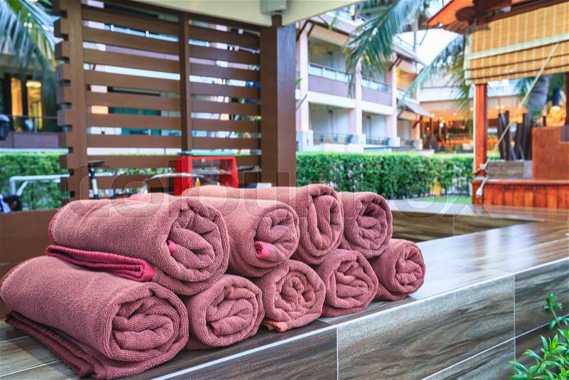 Brown spa towels roll pile for customer service in pool, stock photo