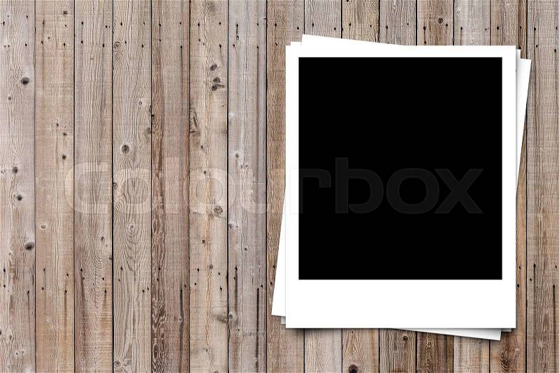 Blank photo frame on brown wood plank background texture, stock photo