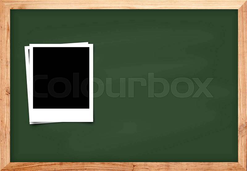 Photo frame on black wood blackboard background for school concept, stock photo