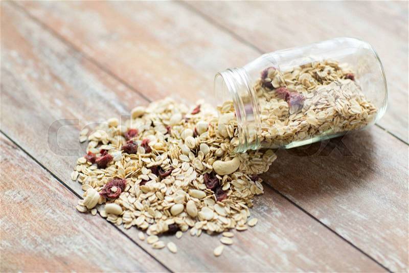 Food, healthy eating and diet concept - close up of jar with granola or muesli on table, stock photo