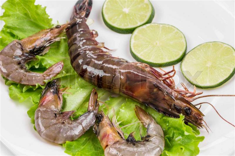 Raw tiger shrimps on plate. Isolated on a white background. , stock photo
